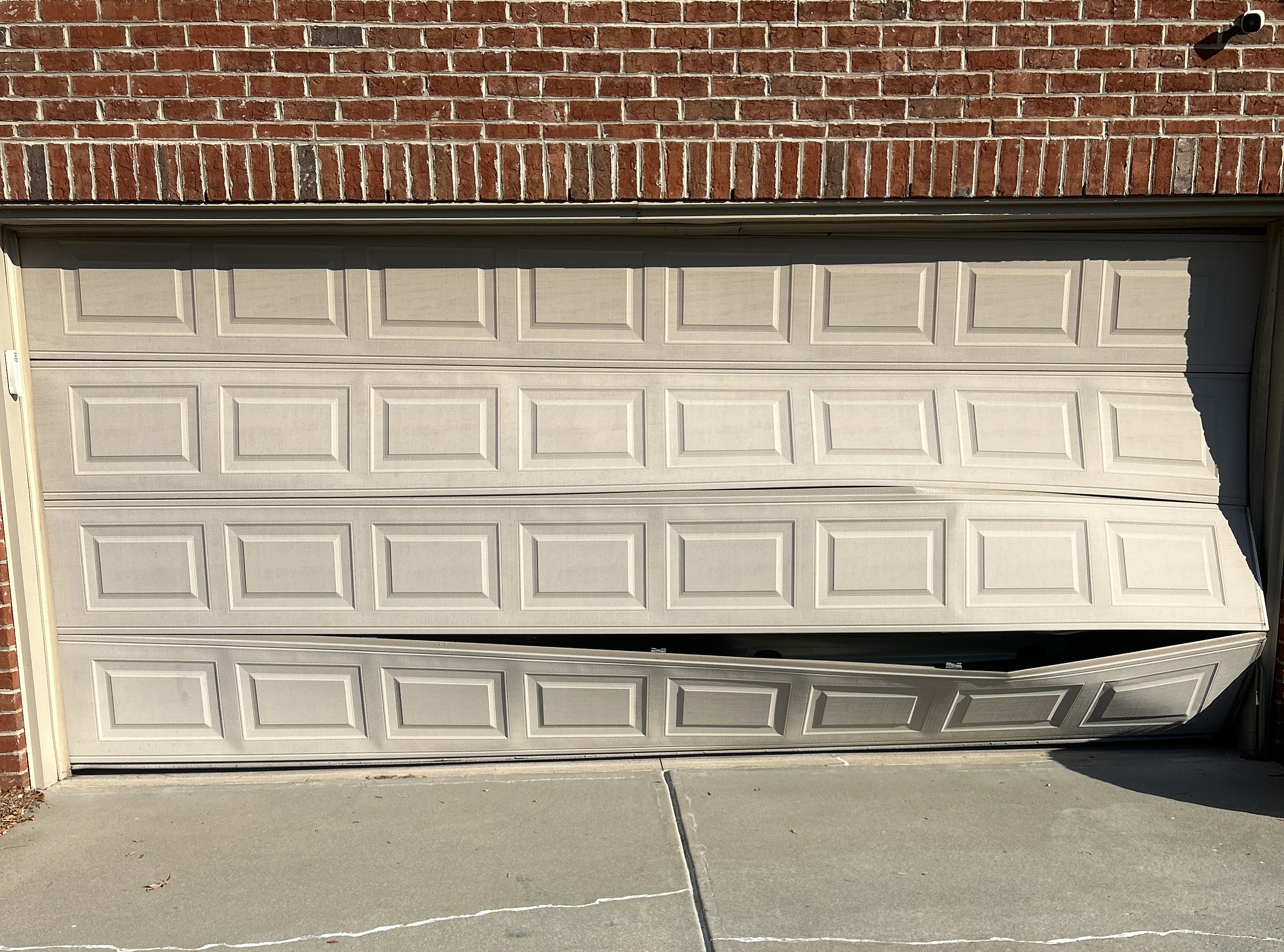 Damaged garage door in need of repair